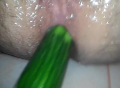 Anal playing with a cucumber